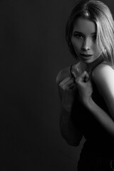 Obraz premium Girl on a black background in fashionable clothes