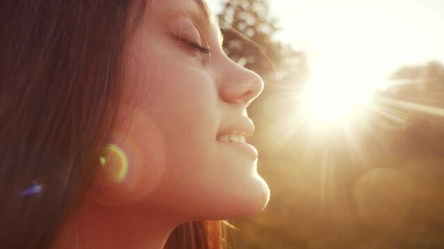 happy girl teen child closed her eyes fantasy dream. teenage kid wants a dream come portrait at sunset. woman daughter silhouette dream of a happy childhood. free face sister closed eyes