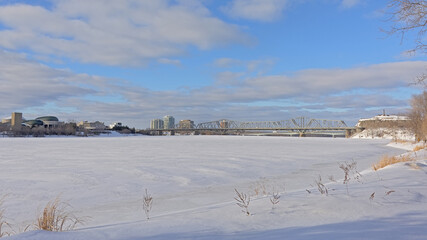 Fototapeta na wymiar Frozen Ottawa river with cities of Ottawa and gatineau on the embankments, conected by Alexandra brdige. Canada. Panoramic view 