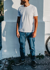 Young bearded hipster guy wearing white blank t-shirt. Mock-up for print. T-shirt template.