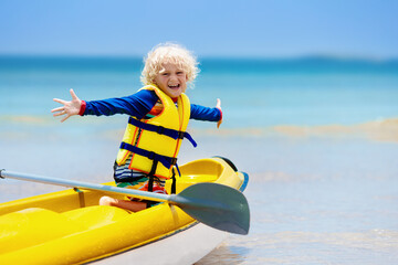 Obraz premium Kids kayaking in ocean. Children in kayak in tropical sea