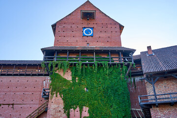 Old redbrick castle building with sweeper on it's walls 