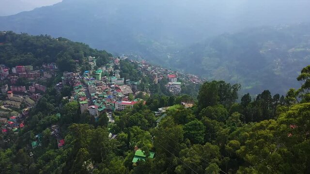 Rising drone reveal of the mountainous city of Gangtok, Sikkim - India .