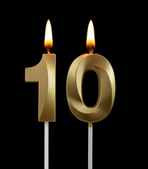 Burning golden birthday candles isolated on black background, number 10	