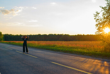 Obraz premium female model plus size in a dark green suit on the road