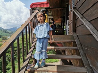 A little girl walking on the wooden floor