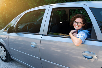 Smiling woman on the back seat of car