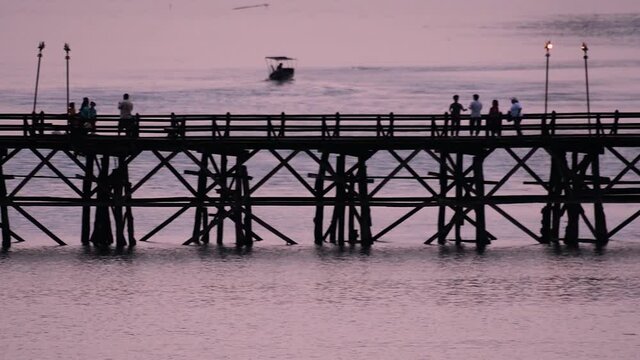 The Mon Bridge is an old wooden bridge located in Sangkla, Thailand. Monks and people cross before sunrise to earn merits and take blessings; in the afternoon, a leisure place to meet friends.