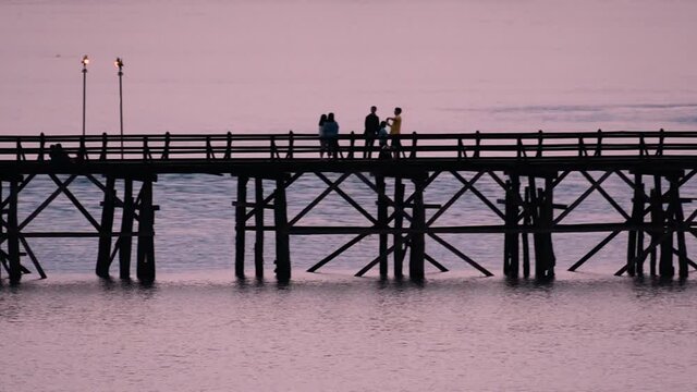 The Mon Bridge is an old wooden bridge located in Sangkla, Thailand. Monks and people cross before sunrise to earn merits and take blessings; in the afternoon, a leisure place to meet friends.