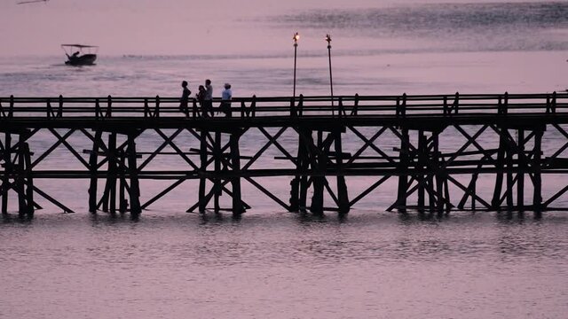 The Mon Bridge is an old wooden bridge located in Sangkla, Thailand. Monks and people cross before sunrise to earn merits and take blessings; in the afternoon, a leisure place to meet friends.