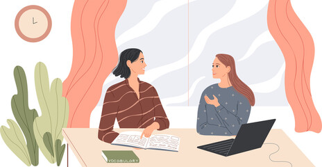 Two women sit at the desk and talk.