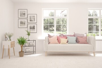 White living room with sofa and summer landscape in window. Scandinavian interior design. 3D illustration
