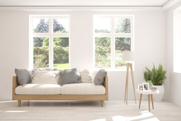 White living room with sofa and summer landscape in window. Scandinavian interior design. 3D illustration