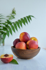 Peaches in a wooden bowl