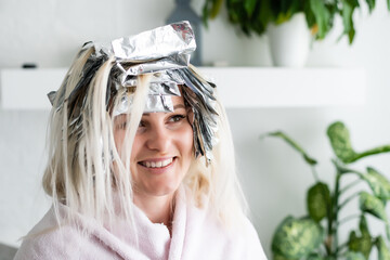 woman dyes her hair foil at home