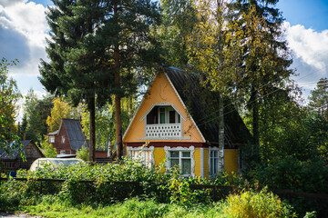 A typical russian summer village in the greenery of trees and flowers on a warm sunny day. Country...