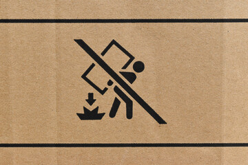 Close Up of cardboard box with packaging symbols as background. Package box with symbol indicating fragile item.