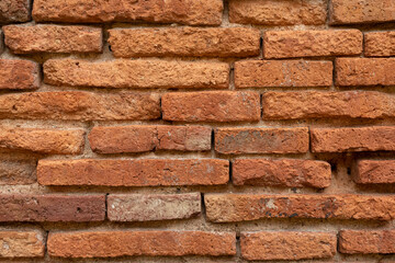Old brick wall, old texture of red stone blocks closeup.