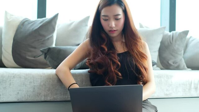 Asian businesswoman executive relax in office sit on sofa hold hands behind head enjoy business success think of future vision dream feel stress free and peace of mind concept.