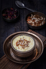 Fototapeta na wymiar Kheer or Payasam is a rice pudding served in traditional utensils