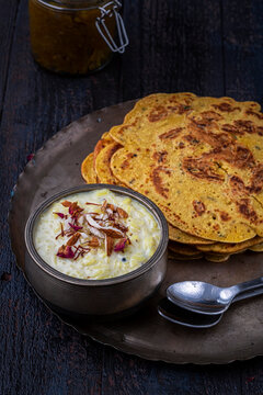 Kheer and besan puda, traditional punjabi foods served in traditional utensils