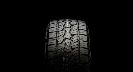 tire for SUVs and crossovers with powerful checkers and grapples close-up on a black background