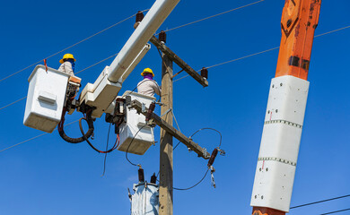 maintenance of electricians work with high voltage electricity on the hydraulic bucket