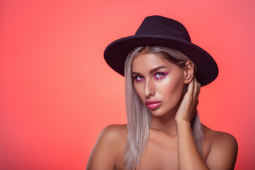 Portrait of Beautiful Caucasian Blonde Girl in Black Hat Over Студио Background with Bright Facial Make-Up. Horizontal Image