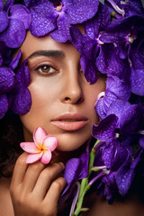 Woman with violet flowers. Fashion photo.