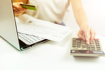 credit card and calculator in hand, the concept of online shopping