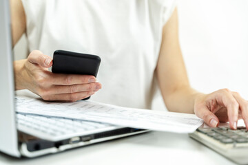 Fototapeta premium smartphone and receipts in the girl's hand, online payment concept