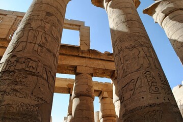 Low angle view of carved hieroglyphics themed columns at Hypostyle Hall in Karnak Temple. Thebes...