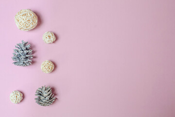 Christmas composition. Pine cones, Christmas balls on a pink background. Flat lay, top view, copy space