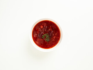 red bean soup in a white bowl on a white table, borsch, top view