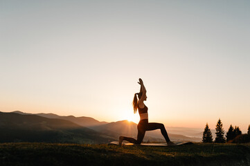 Silhouette woman balanced, practicing meditate and zen energy yoga in mountains. Healthy lifestyle...