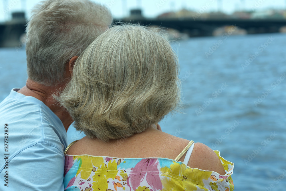 Poster Amusing elderly couple having rest near river