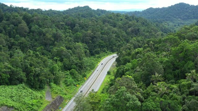 Footage 4k B-roll Aerial drone view of Southern Thailand Road with green jungle in Thailand.