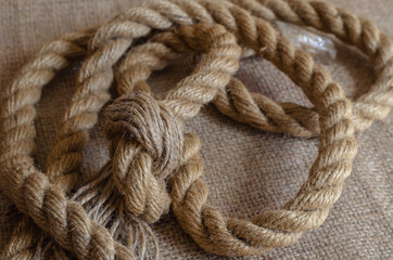 Thick natural rope randomly laid out on sackcloth.