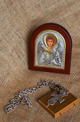 Icon of the Archangel Michael, pectoral cross and wooden joke on sackcloth.