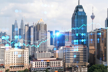 Forex and stock market chart hologram over panorama city view of Kuala Lumpur. KL is the financial center in Malaysia, Asia. The concept of international trading. Double exposure.