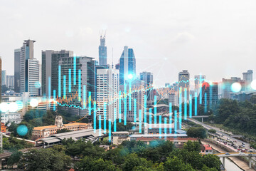 Forex and stock market chart hologram over panorama city view of Kuala Lumpur. KL is the financial center in Malaysia, Asia. The concept of international trading. Double exposure.