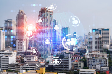 Social media icons hologram over panorama city view of Bangkok, Asia. The concept of people networking and connections. Double exposure.