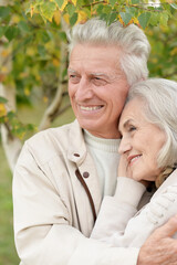 Beautiful senior couple hugging in the park