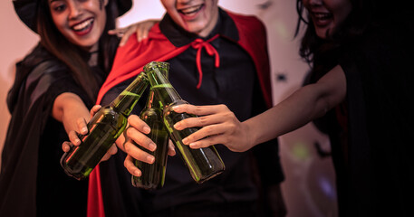 Young people are drinking and celebrating a glass at a halloween party