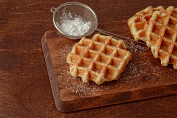 fresh hot Belgian waffles with icing sugar