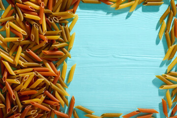 Uncooked dried pasta on wooden background. Space for text. Top View.