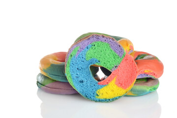 pile of rainbow bagels with cross section