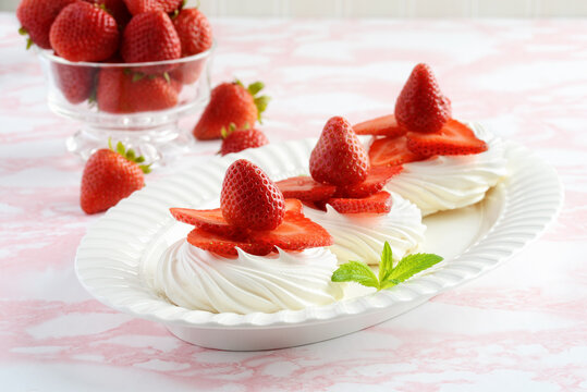 platter of strawberry meringue nests with mint