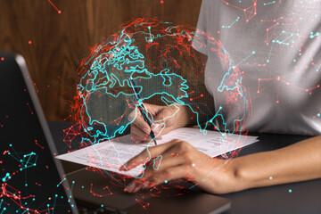 Businesswoman typing on laptop in office. Planet earth world map hologram. International business concept. Double exposure.