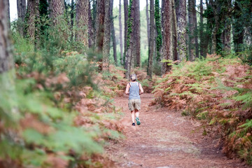 middle-aged woman running in the forest